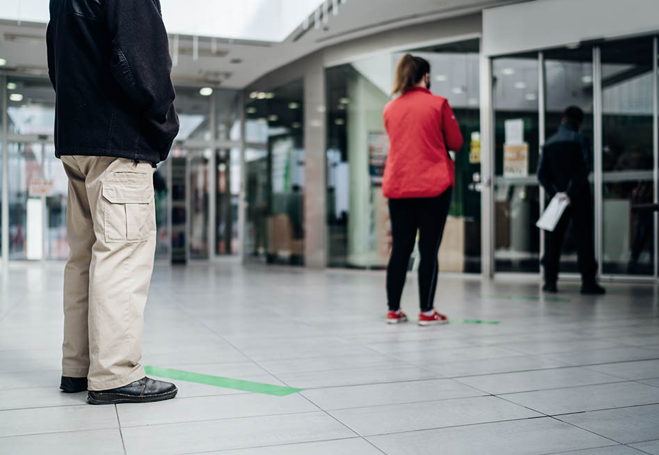 Image of person from behind walking out of a building to represent and employee facing reduced hours or days of work