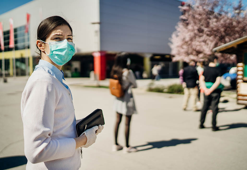 woman in mask reflecting employees impacted by covid redundancies