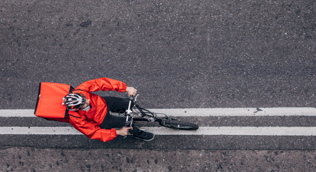 Aerial shot of an on-demand delivery rider. Used to reflect a Deliveroo rider in a sham contracting dispute.