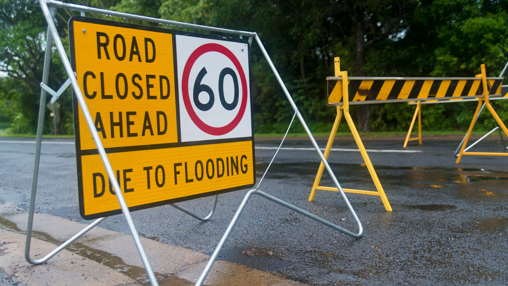 Road sign indicating road closed due to a natural disaster