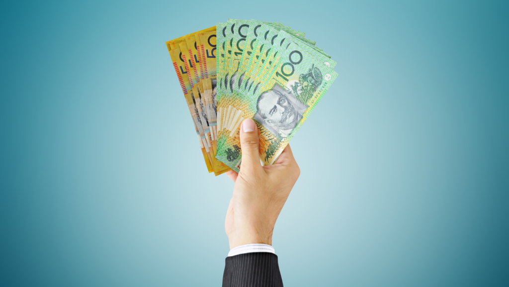 hand holding out Australian dollars